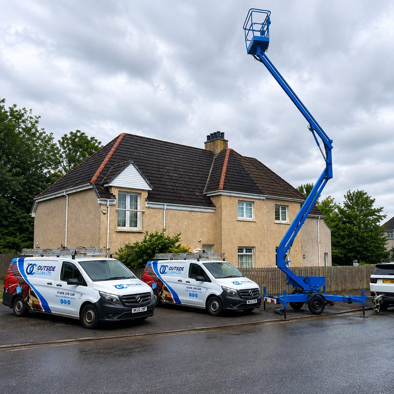 The Outside Clean vans hard at work in Glasgow cleaning a roof with a cherry picker